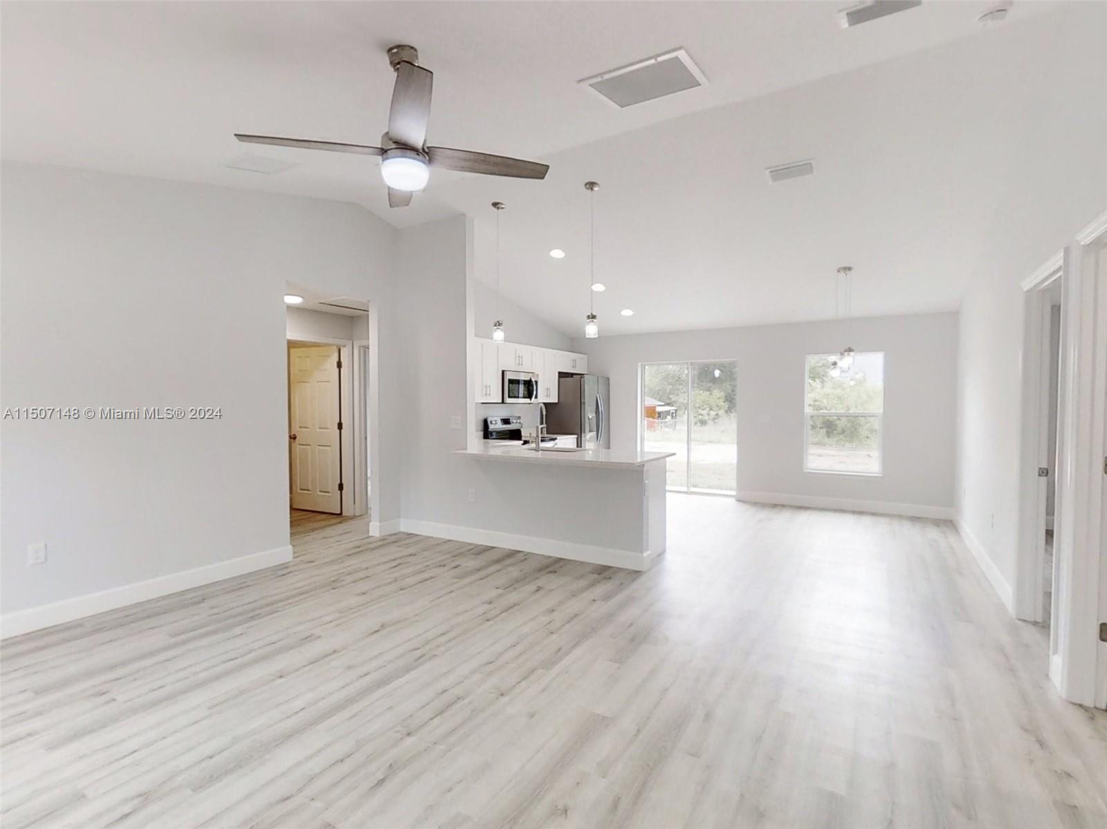 14512 Southwest 25th Lane Ocala, FL 34481 - Photo 5 of 30 a view of a kitchen with wooden floor and a kitchen