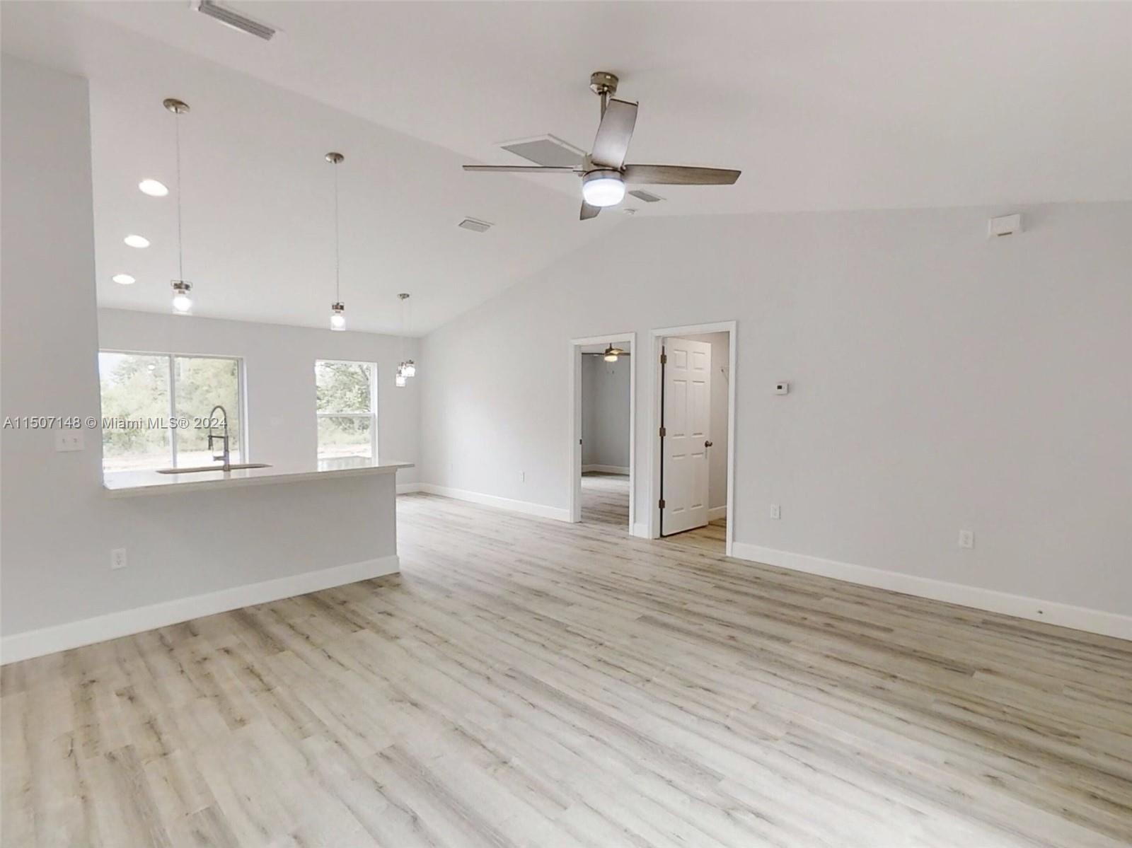 14512 Southwest 25th Lane Ocala, FL 34481 - Photo 6 of 30 a view of an empty room with wooden floor and a window