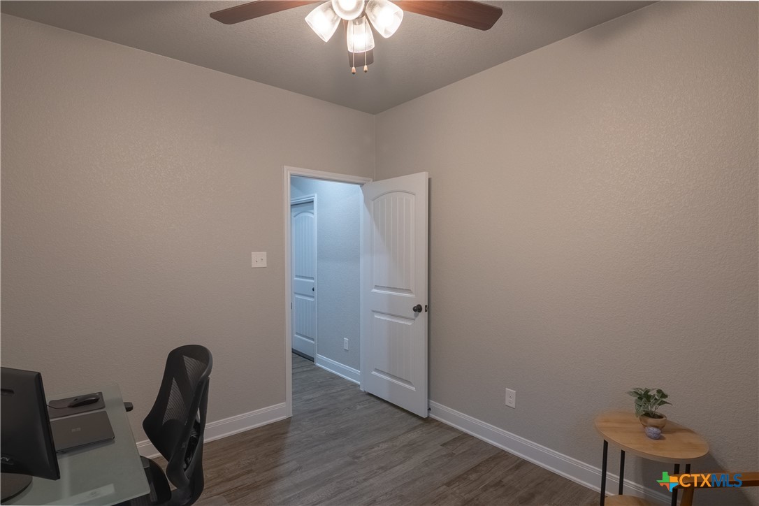 7909 McCulloch Road Temple, TX 76502 - Photo 28 of 46 a view of a workspace with furniture and wooden floor