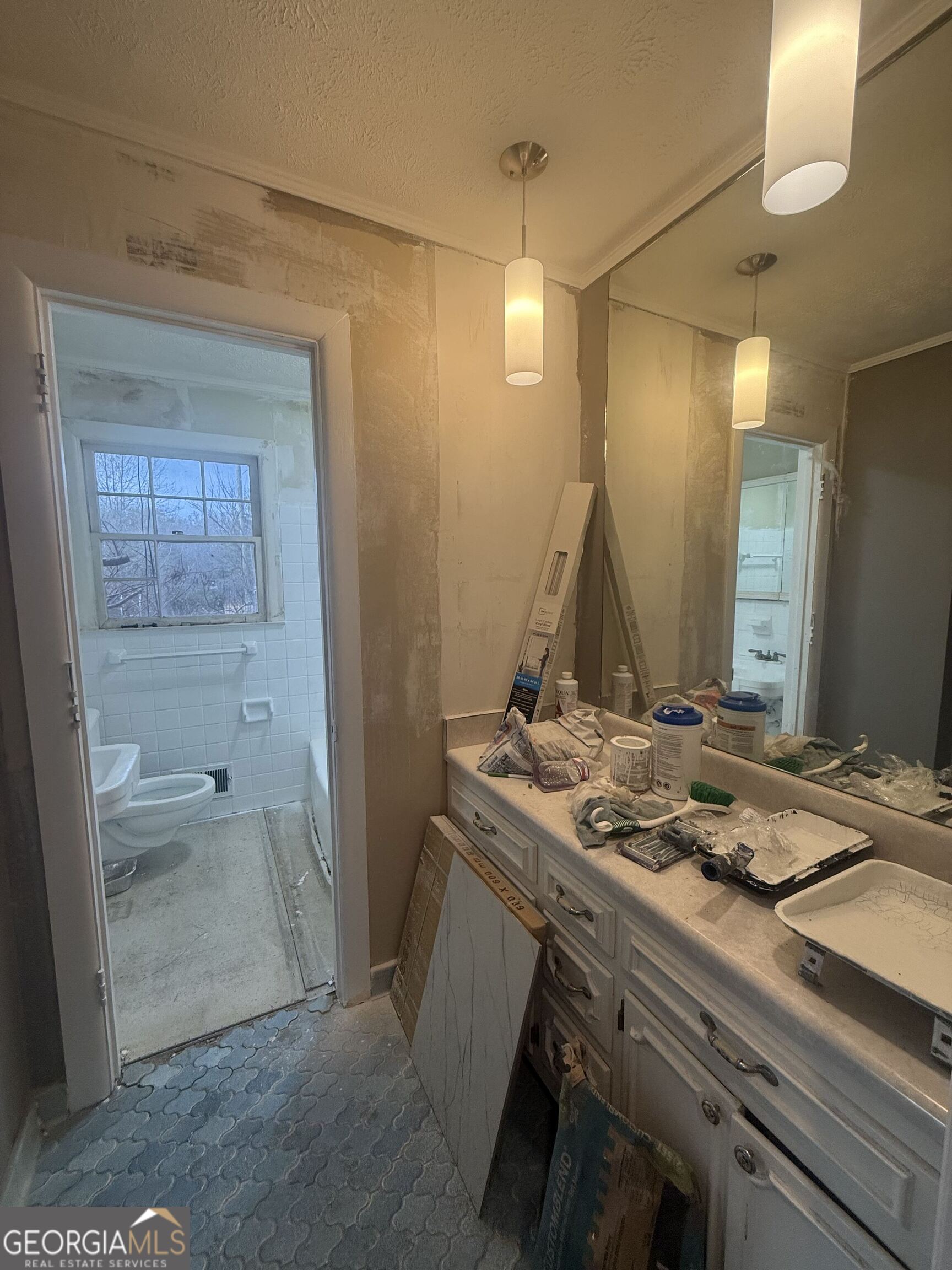 3861 Newnan Road Griffin, GA 30223 - Photo 41 of 89 a bathroom with a granite countertop sink a mirror and a shower