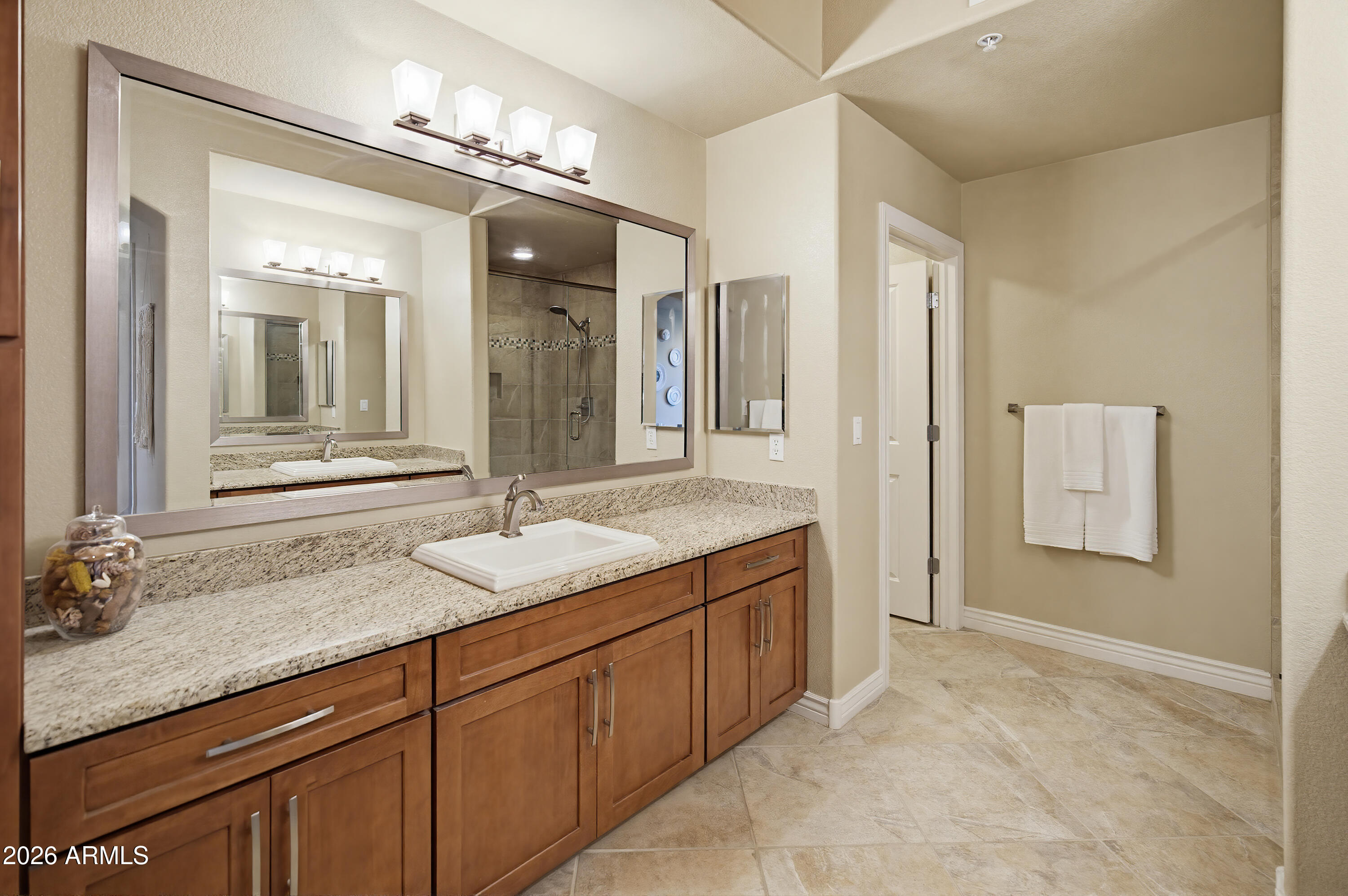 7601 East Indian Bend Road, Unit 3045 Scottsdale, AZ 85250 - Photo 12 of 32 a bathroom with a granite countertop sink and a mirror