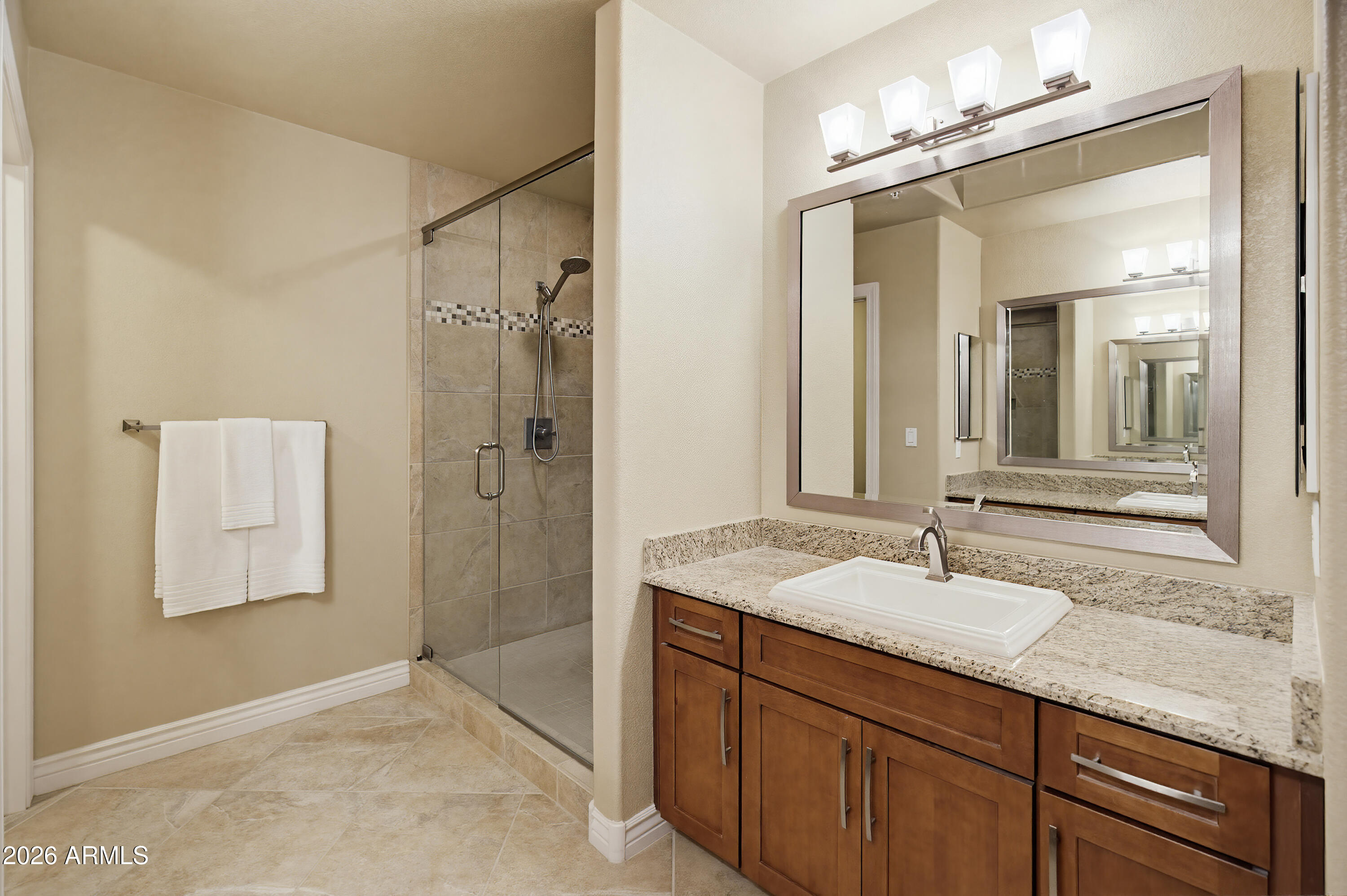 7601 East Indian Bend Road, Unit 3045 Scottsdale, AZ 85250 - Photo 13 of 32 a bathroom with a granite countertop sink a mirror and shower