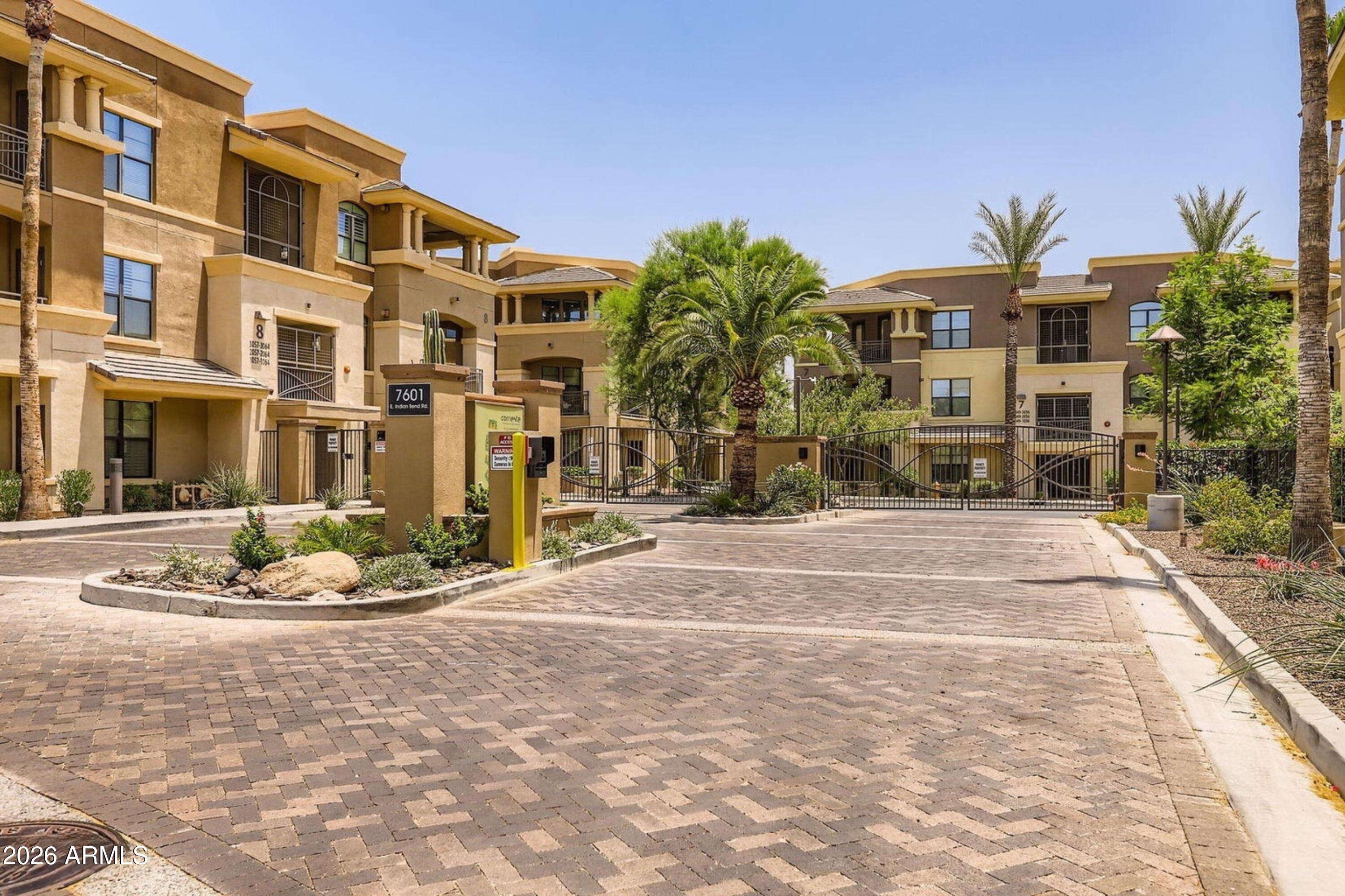 7601 East Indian Bend Road, Unit 3045 Scottsdale, AZ 85250 - Photo 27 of 32 a front view of a building with garden