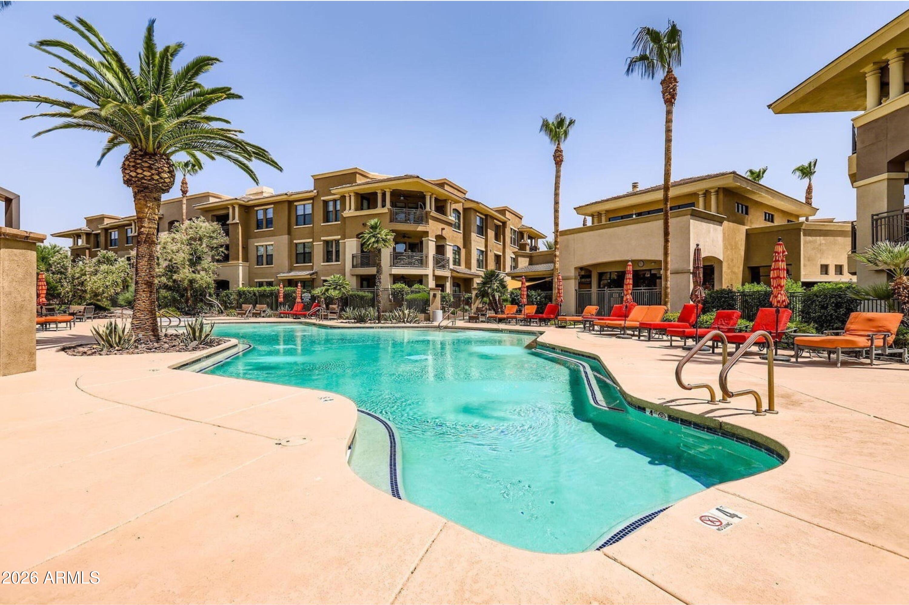 7601 East Indian Bend Road, Unit 3045 Scottsdale, AZ 85250 - Photo 29 of 32 a view of a swimming pool with a bench and tables