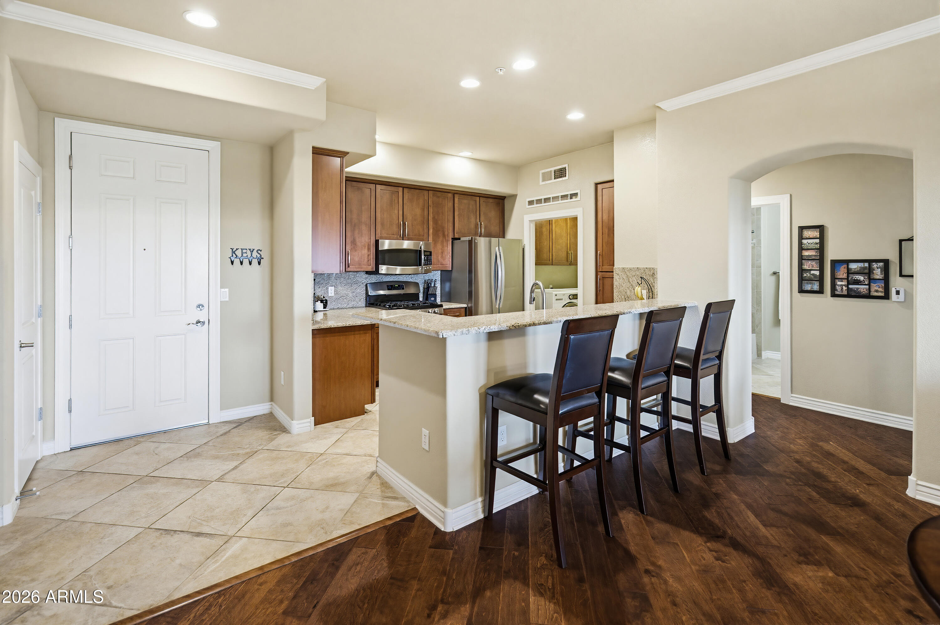 7601 East Indian Bend Road, Unit 3045 Scottsdale, AZ 85250 - Photo 8 of 32 a view of a dining room with furniture and wooden floor