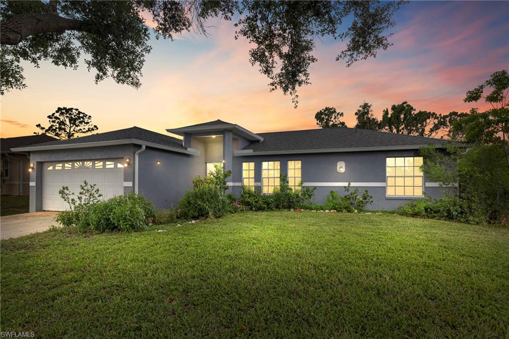 8366 Cardinal Road Fort Myers, FL 33967 - Photo 1 of 25 a front view of a house with garden