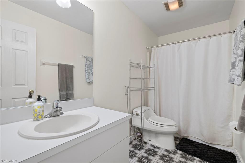 8366 Cardinal Road Fort Myers, FL 33967 - Photo 18 of 25 a bathroom with a sink toilet and shower
