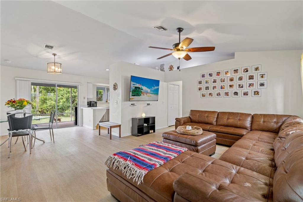 8366 Cardinal Road Fort Myers, FL 33967 - Photo 8 of 25 a living room with furniture a fireplace and a window