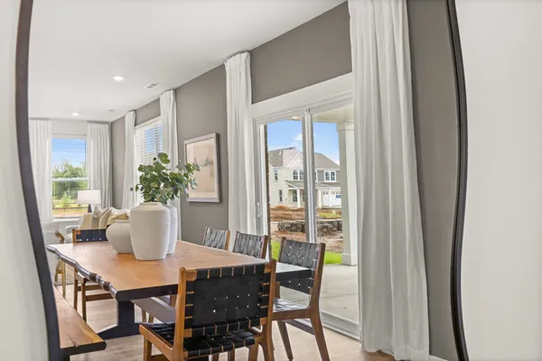 a living room with furniture and a large mirror