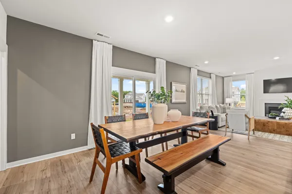 a living room with furniture kitchen view and a flat screen tv