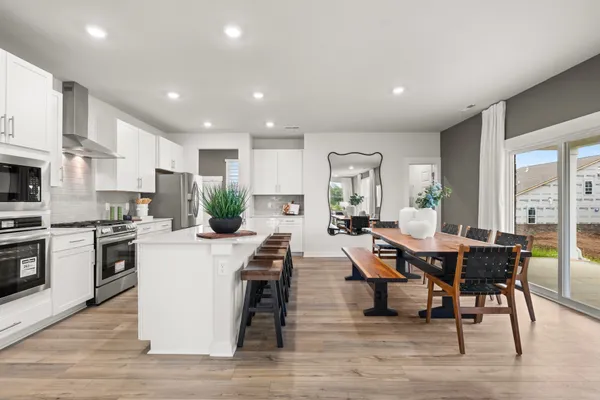 a living room with furniture wooden floor and a large window