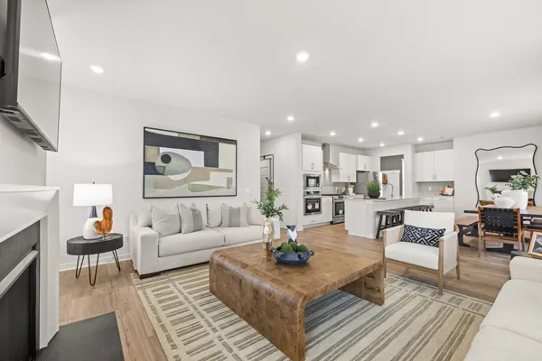 a living room with furniture a rug and a table