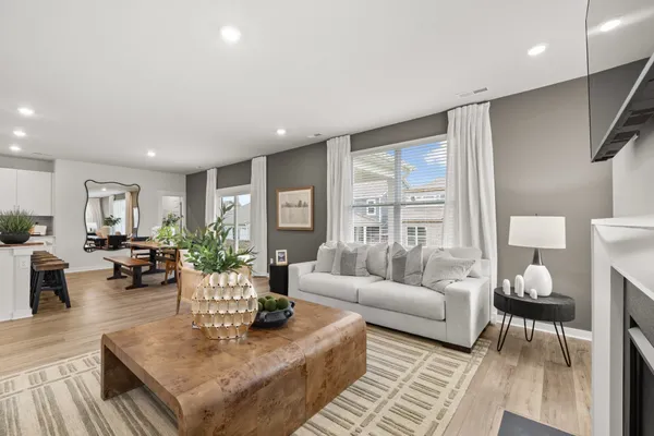 a living room with furniture a table and a potted plant