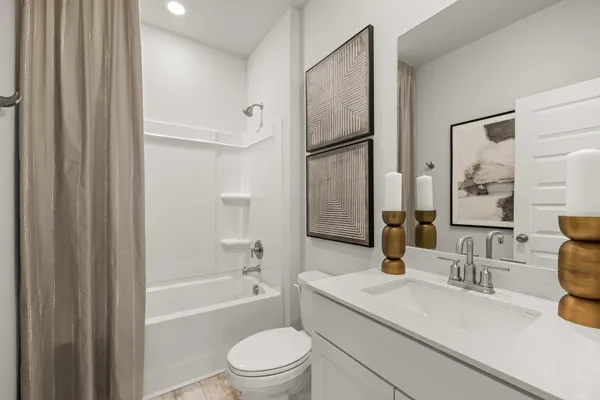 a en suite bathroom with a double sink and shower