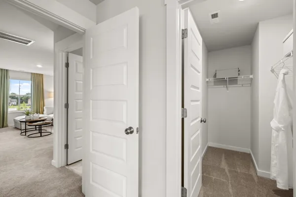 a view of a house with a big yard and large trees