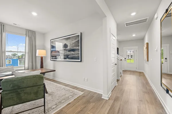 a kitchen with stainless steel appliances granite countertop a stove a refrigerator a white table and chairs