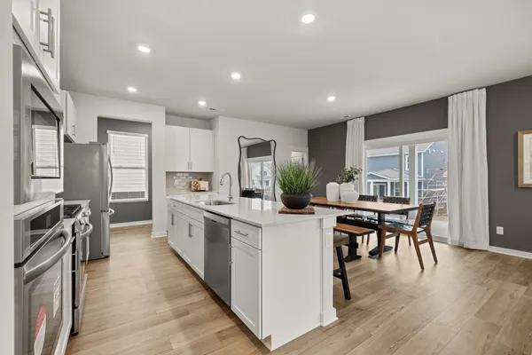 a kitchen with a sink stove and refrigerator