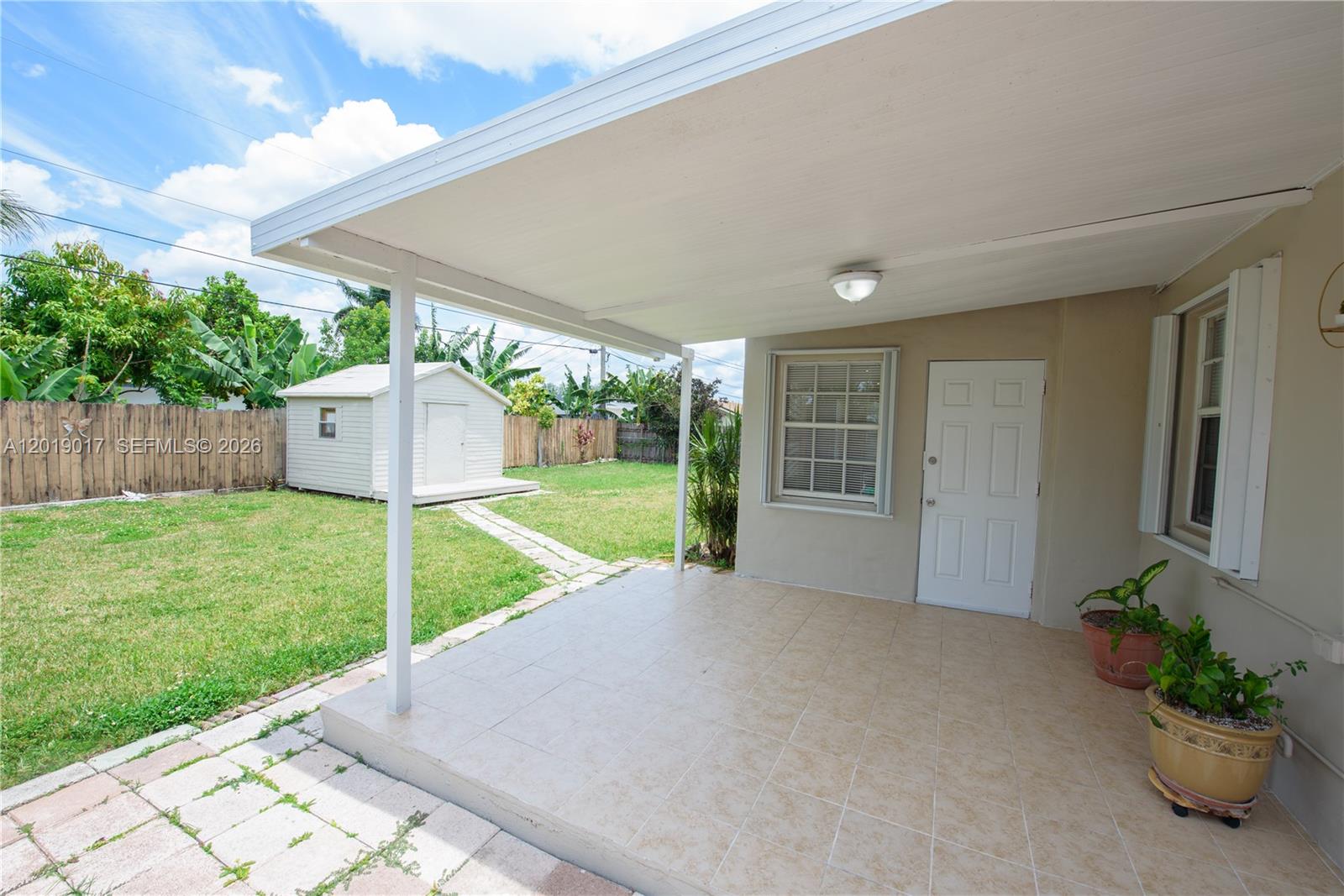 731 Northwest 17th Street Homestead, FL 33030 - Photo 18 of 29 a view of a house with backyard and a garden