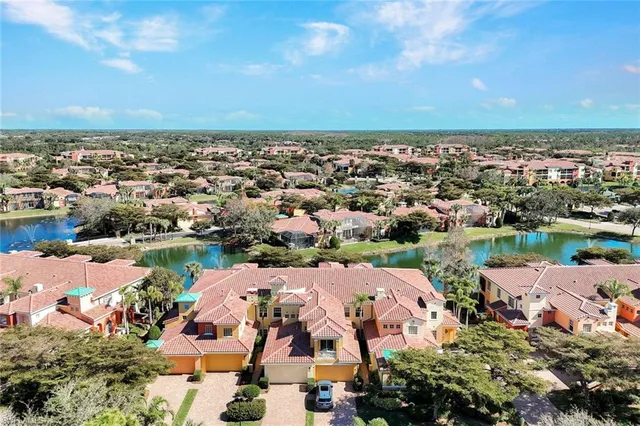 an aerial view of a city with lake view in back