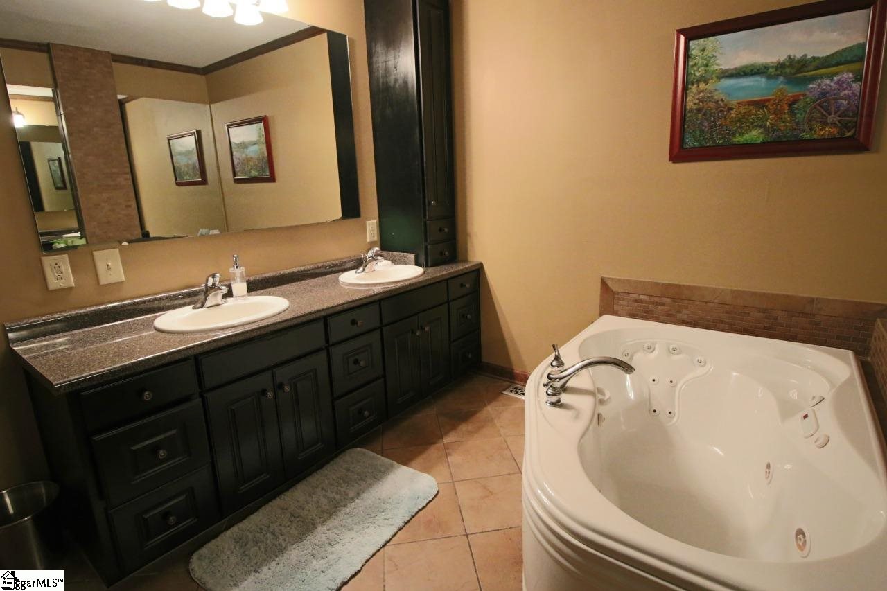 139 Cove Road Clinton, SC 29325 - Photo 11 of 17 Master bath with double vanity, jetted tub and walk-in shower with tiled seat