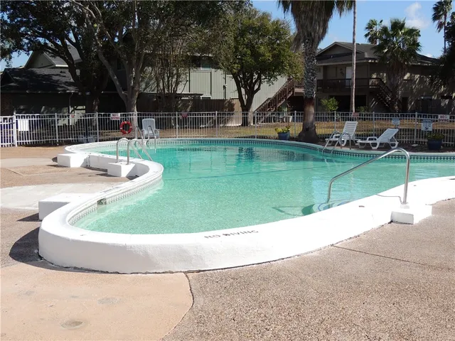 a view of a swimming pool with a sitting area