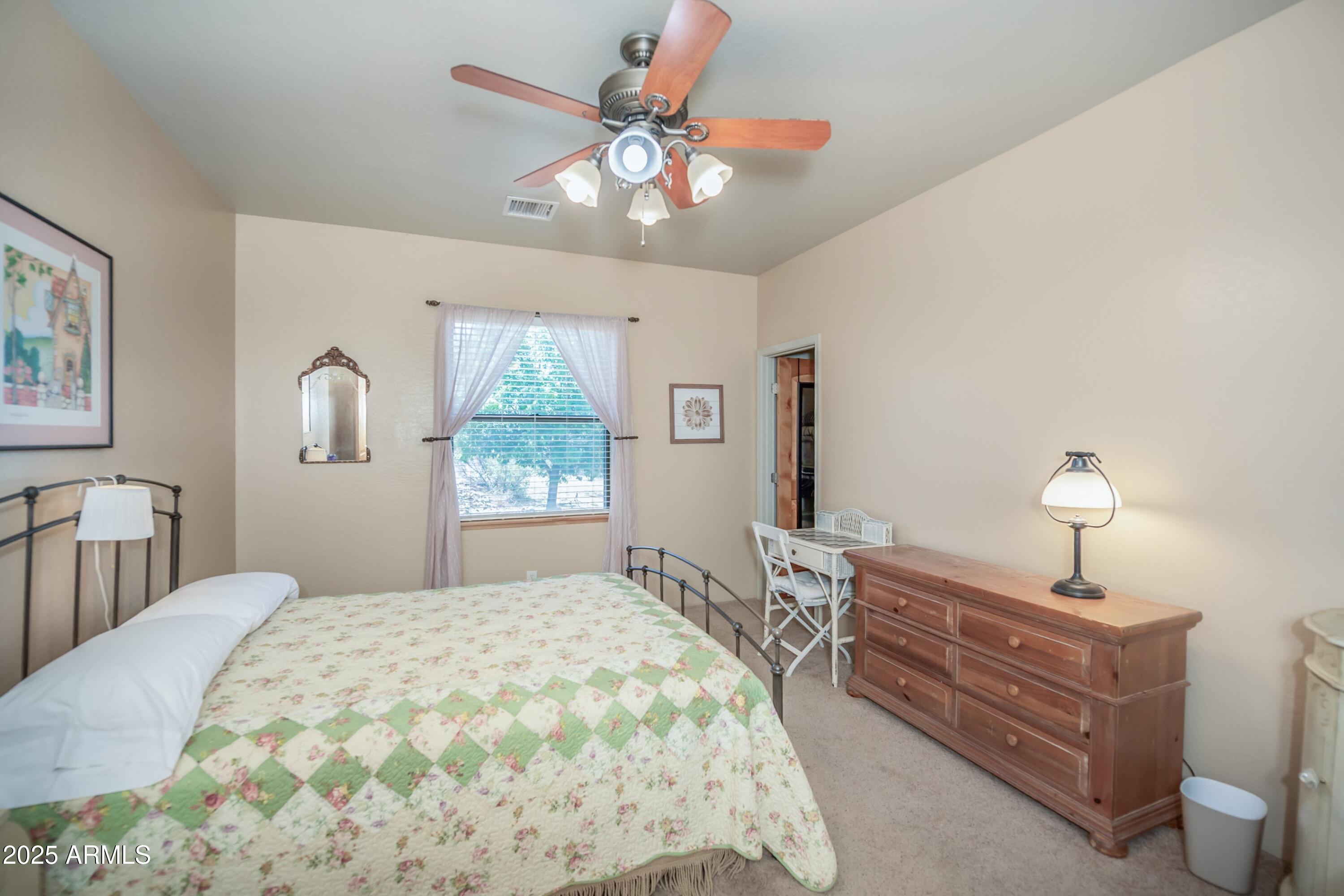 171 South Enchanted Road Dewey, AZ 86327 - Photo 22 of 62 a bedroom with a bed and a chandelier