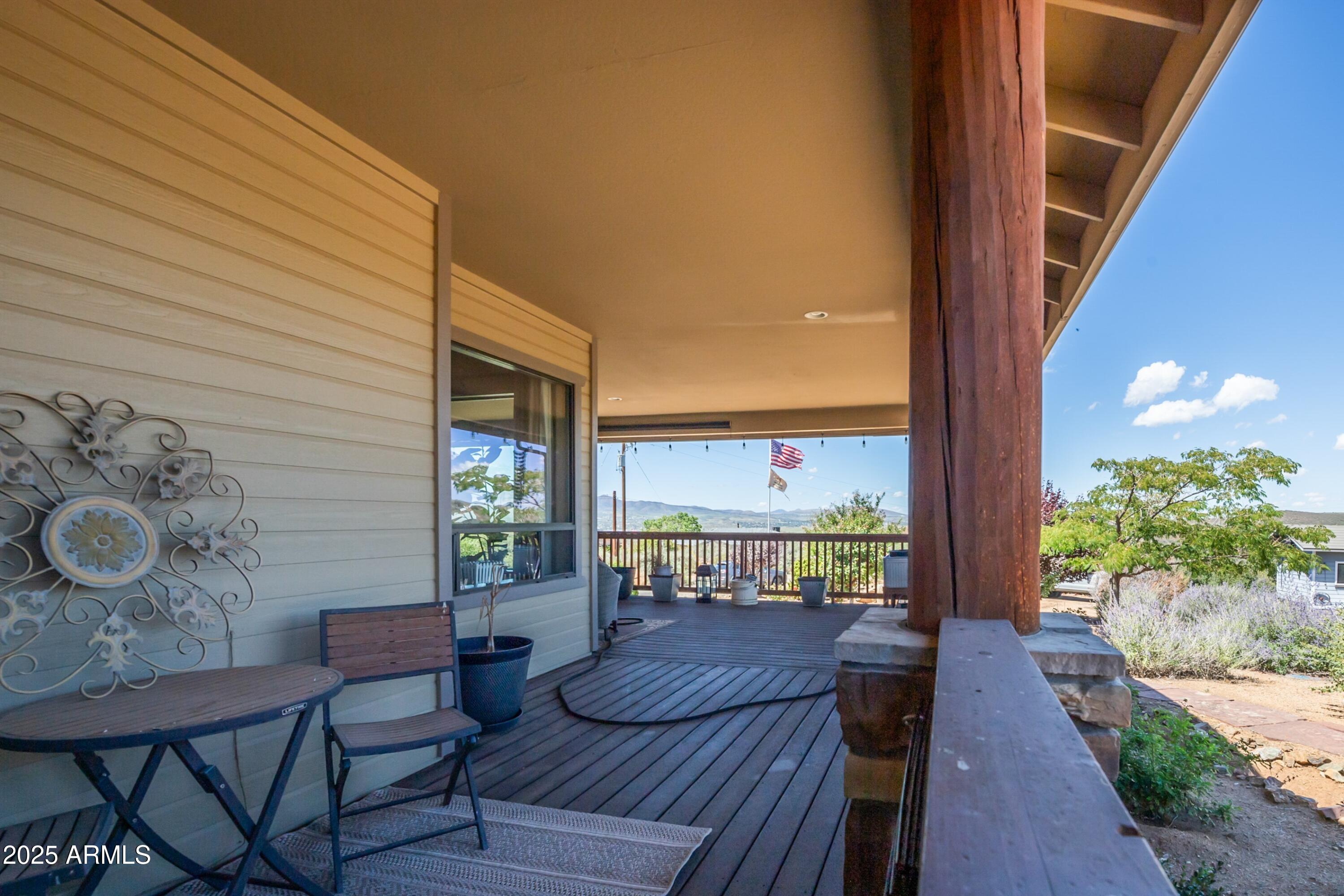 171 South Enchanted Road Dewey, AZ 86327 - Photo 38 of 62 a view of a patio with table and chairs with wooden floor and plants