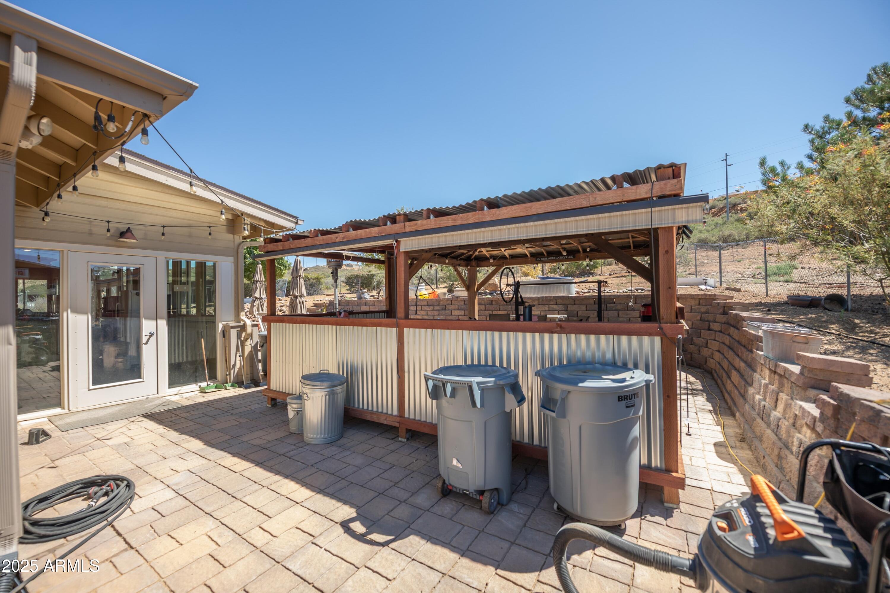 171 South Enchanted Road Dewey, AZ 86327 - Photo 42 of 62 a view of a patio with table and chairs and wooden floor