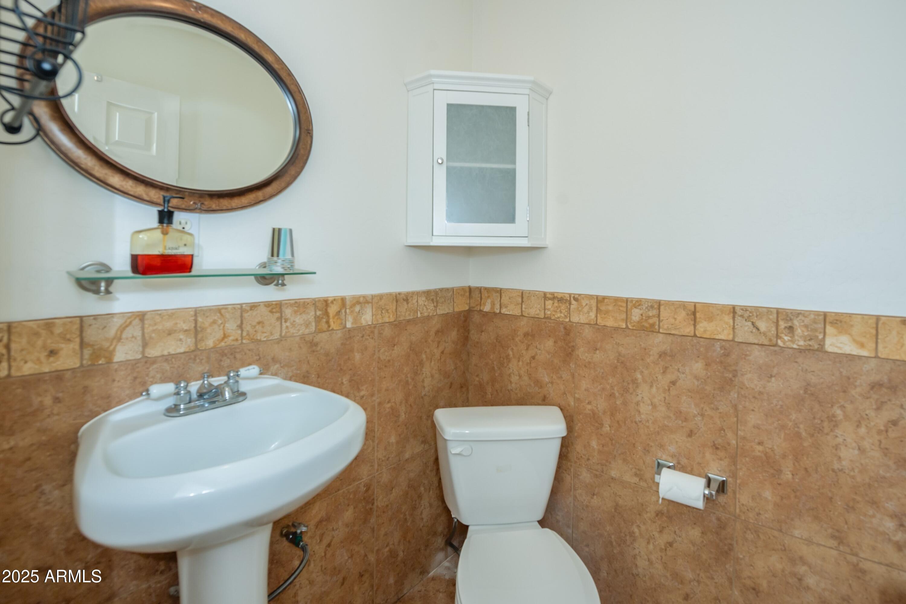 171 South Enchanted Road Dewey, AZ 86327 - Photo 52 of 62 a bathroom with a toilet a sink and a mirror