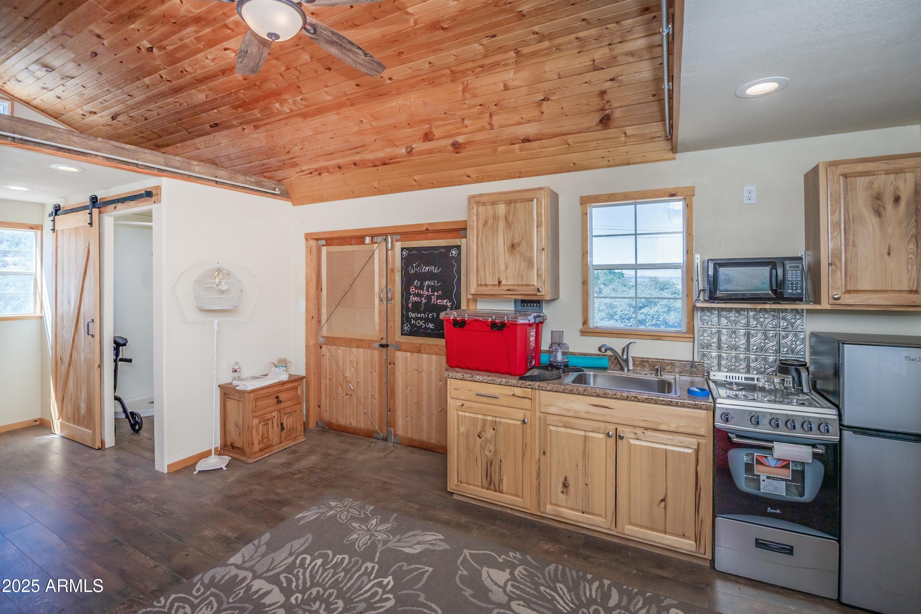 171 South Enchanted Road Dewey, AZ 86327 - Photo 56 of 62 a kitchen with granite countertop a sink stove and cabinets