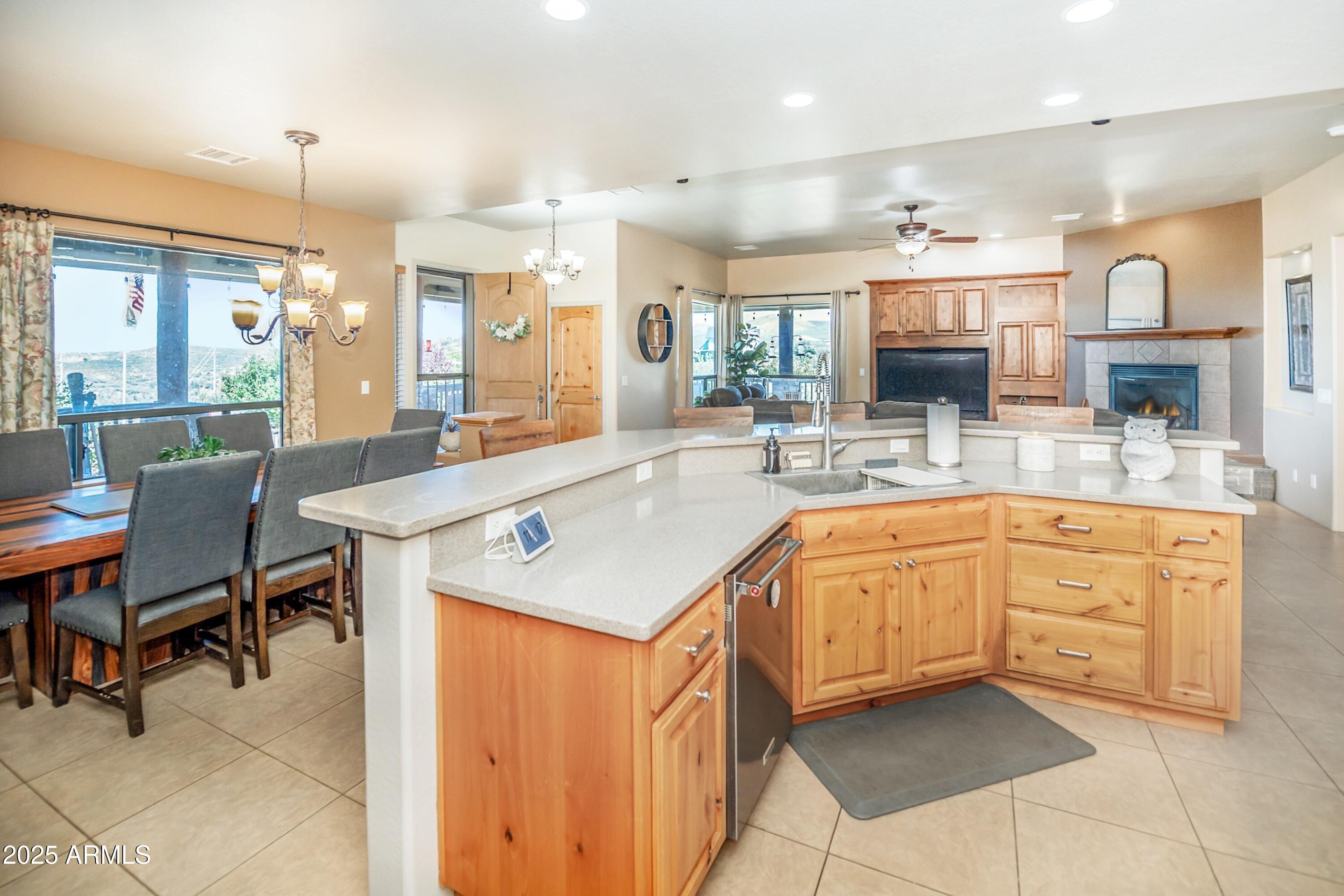 171 South Enchanted Road Dewey, AZ 86327 - Photo 10 of 62 a kitchen with stainless steel appliances granite countertop a sink a stove a dining table and chairs