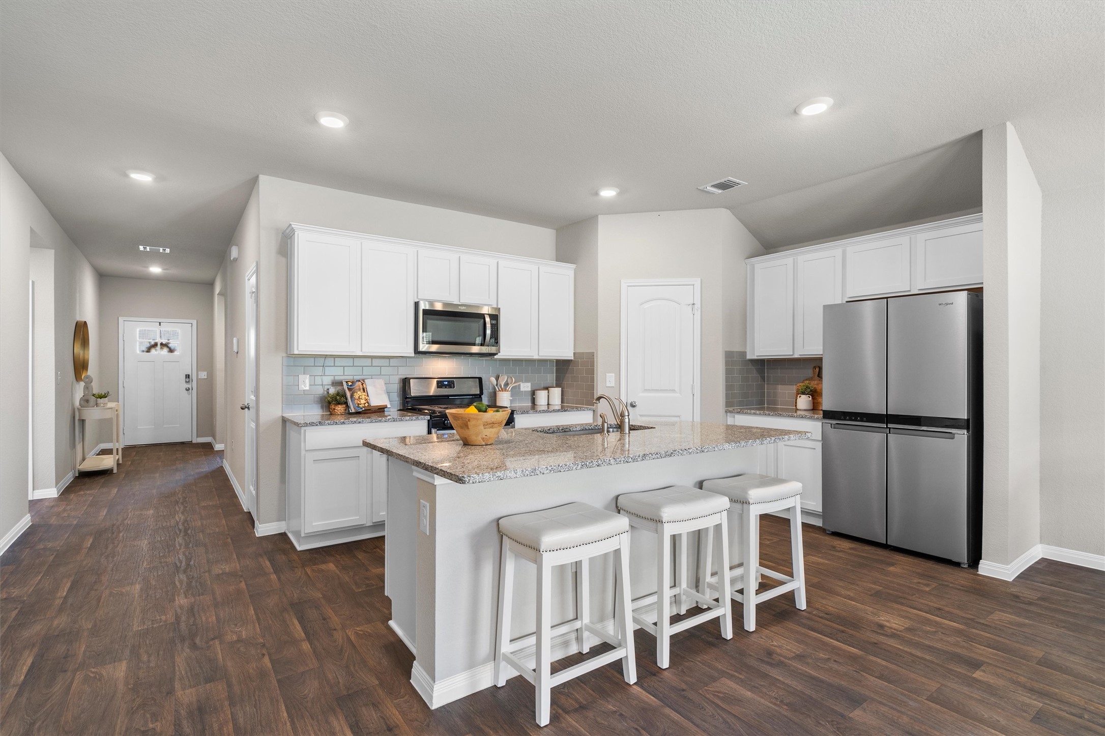 19525 Abigail Fillmore Road Manor, TX 78653 - Photo 5 of 38 A contemporary kitchen boasts a spacious island, granite countertops, and sleek stainless steel appliances, perfect for entertaining.