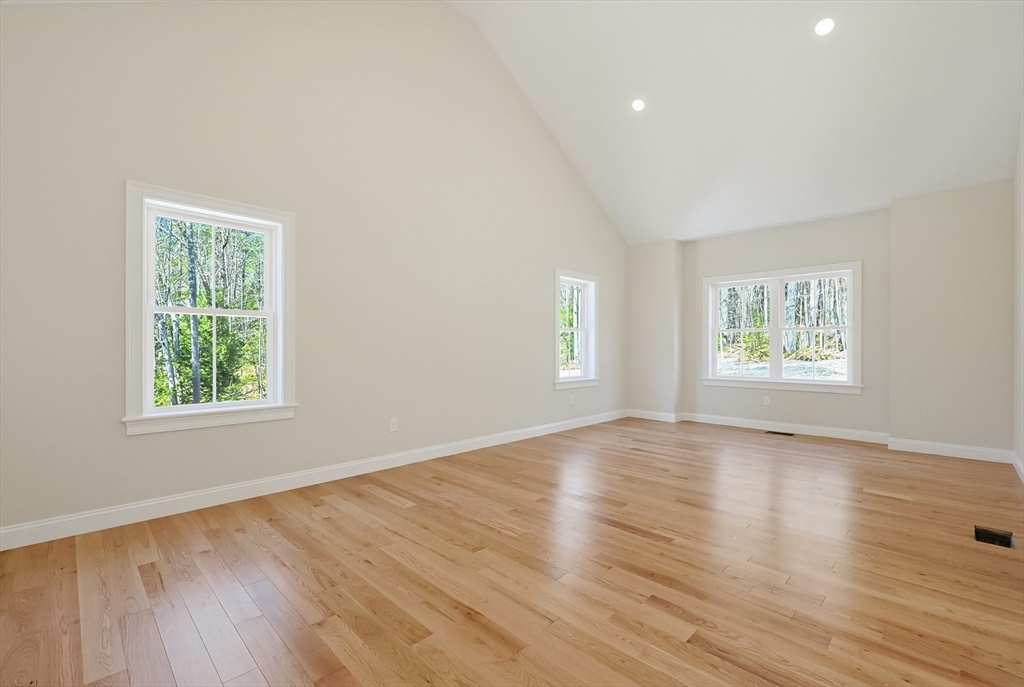 112 West Meadow Road Townsend, MA 01474 - Photo 10 of 38 an empty room with wooden floor and windows