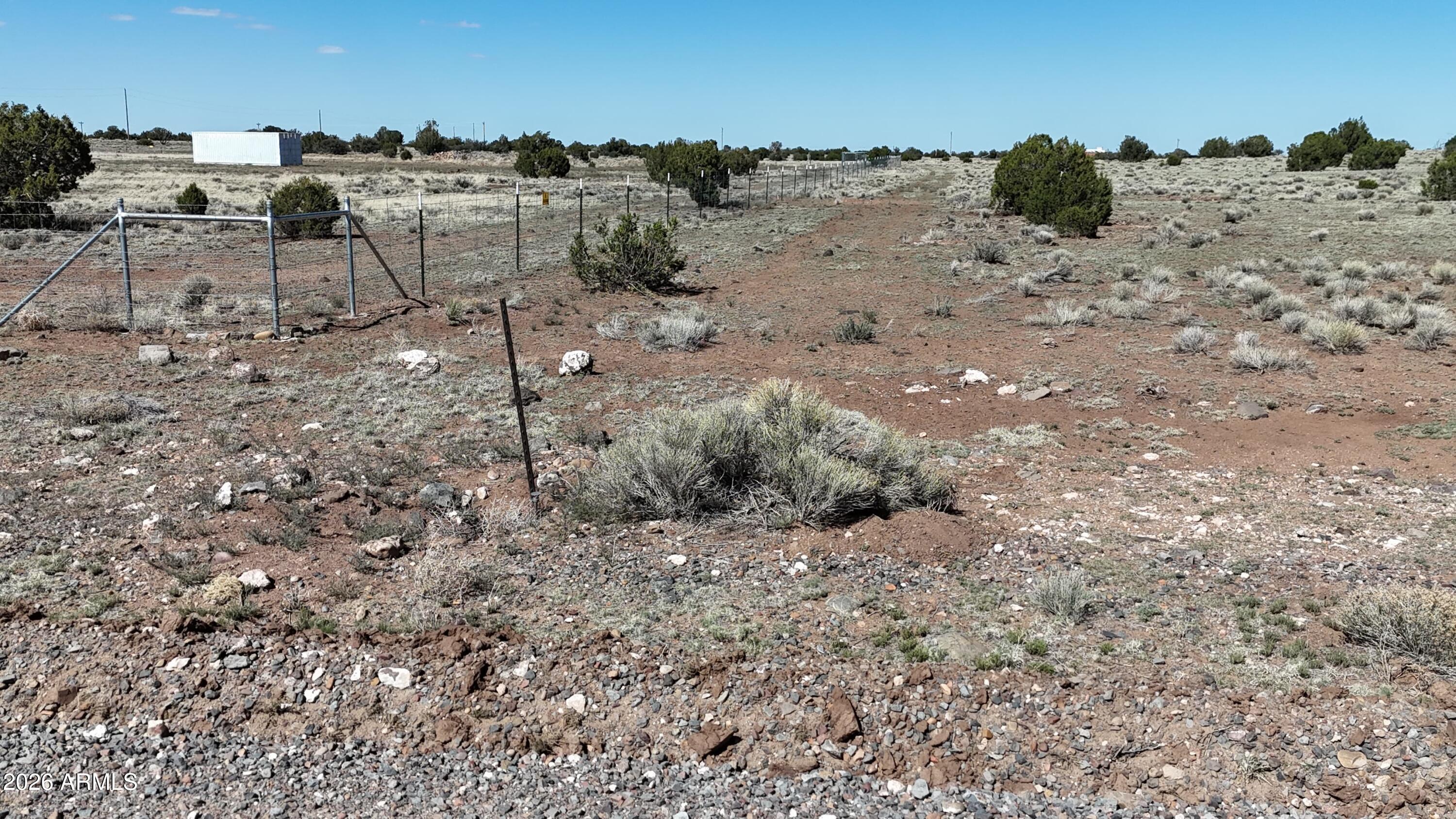Tbd Tbd Windsor Valley Ranch, Unit 142 Concho, AZ 85924 - Photo 11 of 23 a view of a dry yard with wooden fence