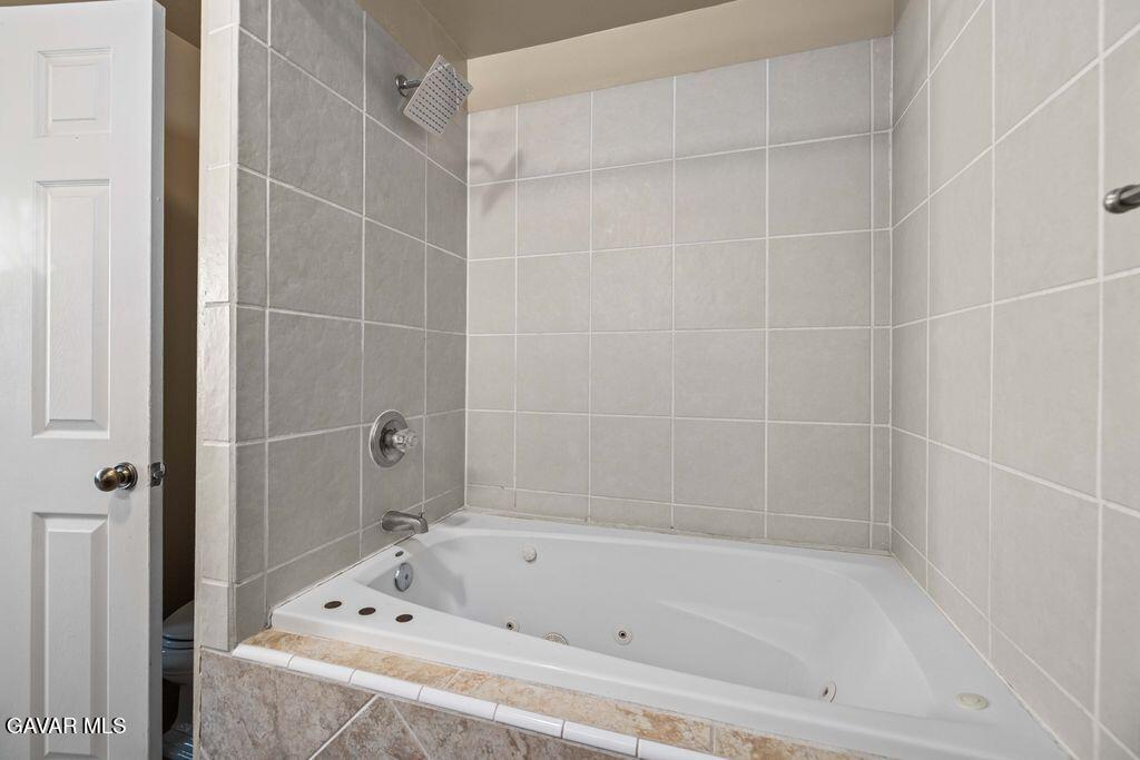 44115 Hunter Court Lancaster, CA 93536 - Photo 14 of 23 a bathroom with a bathtub and a shower