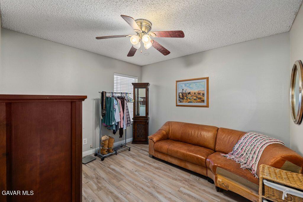 44115 Hunter Court Lancaster, CA 93536 - Photo 18 of 23 a living room with furniture ceiling fan and a window