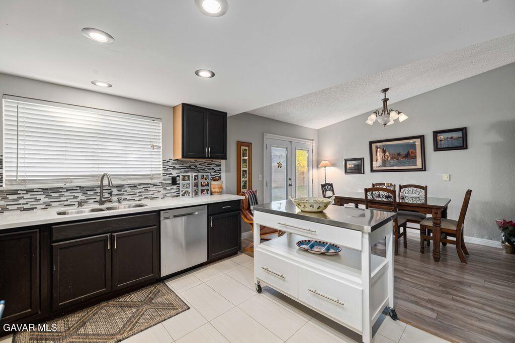 44115 Hunter Court Lancaster, CA 93536 - Photo 2 of 23 a kitchen with stainless steel appliances granite countertop a sink and stove