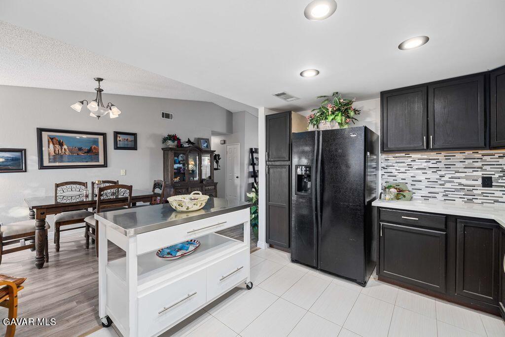 44115 Hunter Court Lancaster, CA 93536 - Photo 9 of 23 a kitchen with stainless steel appliances granite countertop a sink and refrigerator