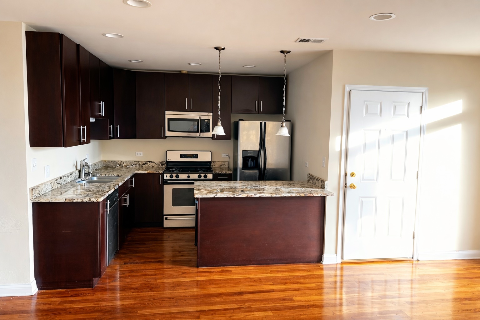 3336 West 19th Street, Unit 1W Chicago, IL 60623 - Photo 2 of 10 a kitchen with stainless steel appliances granite countertop a stove and a sink