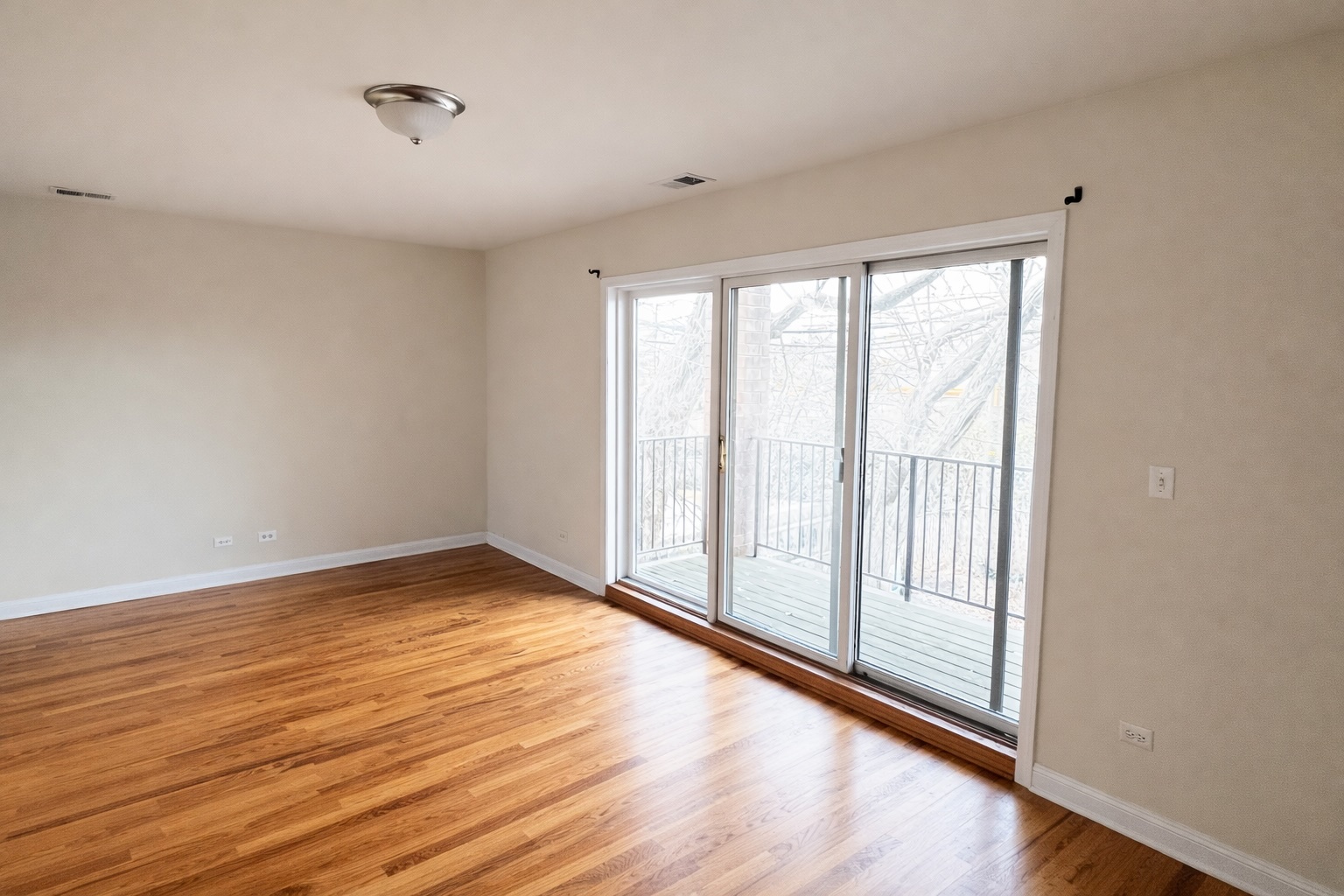 3336 West 19th Street, Unit 1W Chicago, IL 60623 - Photo 4 of 10 a view of an empty room with wooden floor and a window