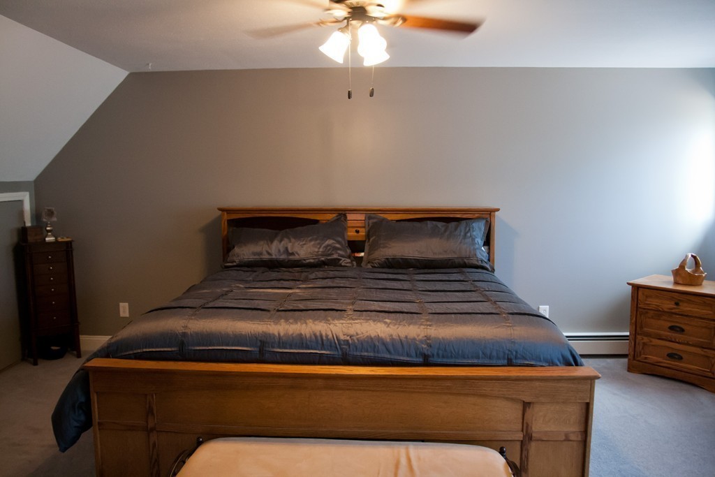 70 Bacon Road Ware, MA 01082 - Photo 25 of 30 a bedroom with a bed and a chandelier