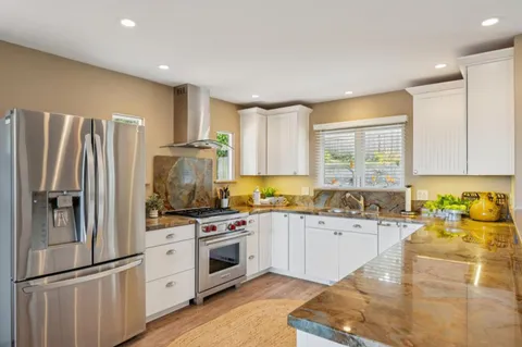 a kitchen with a stove and a sink