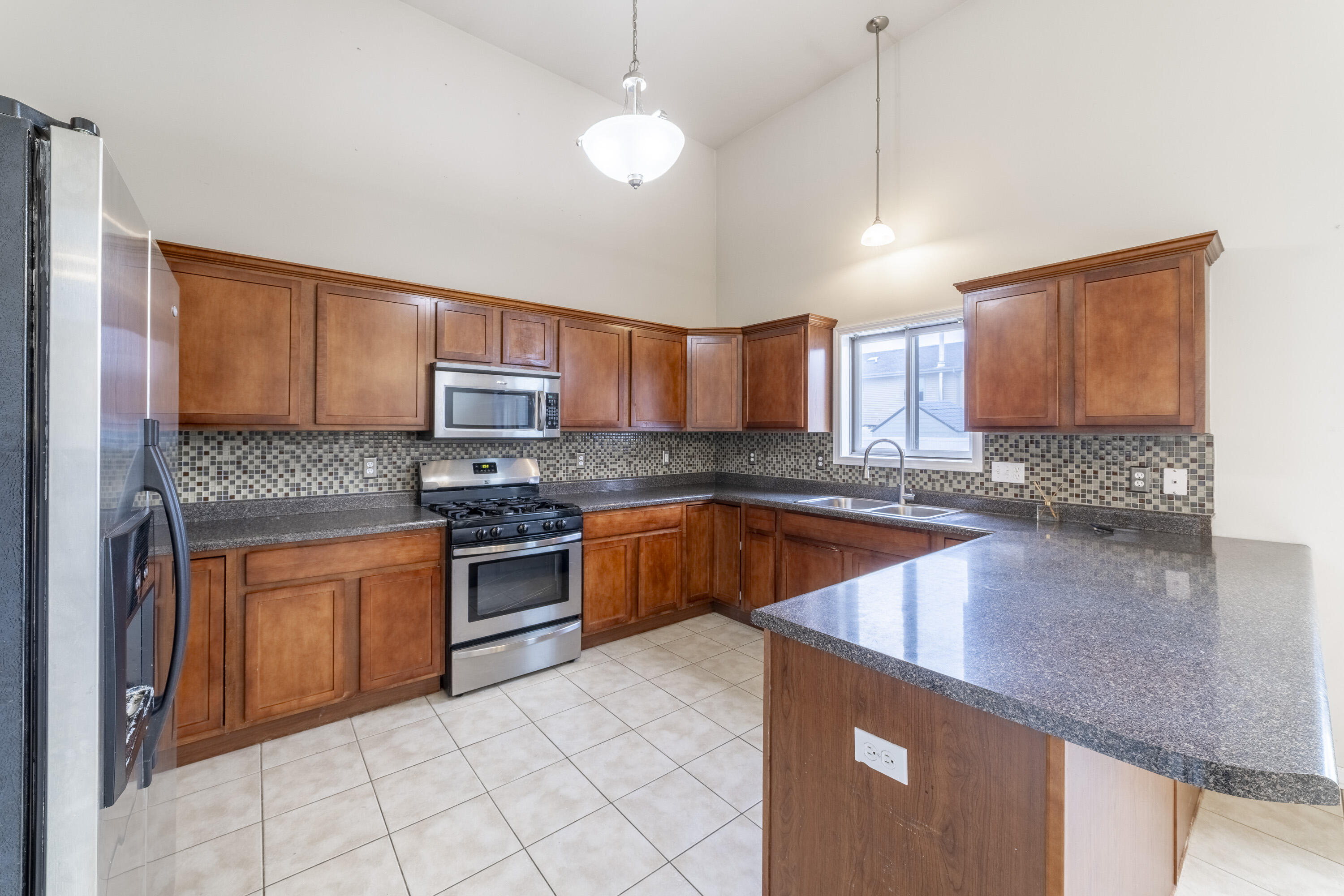 12719 Wheeler Street Cedar Lake, IN 46303 - Photo 11 of 48 a kitchen with stainless steel appliances granite countertop a stove sink and cabinets