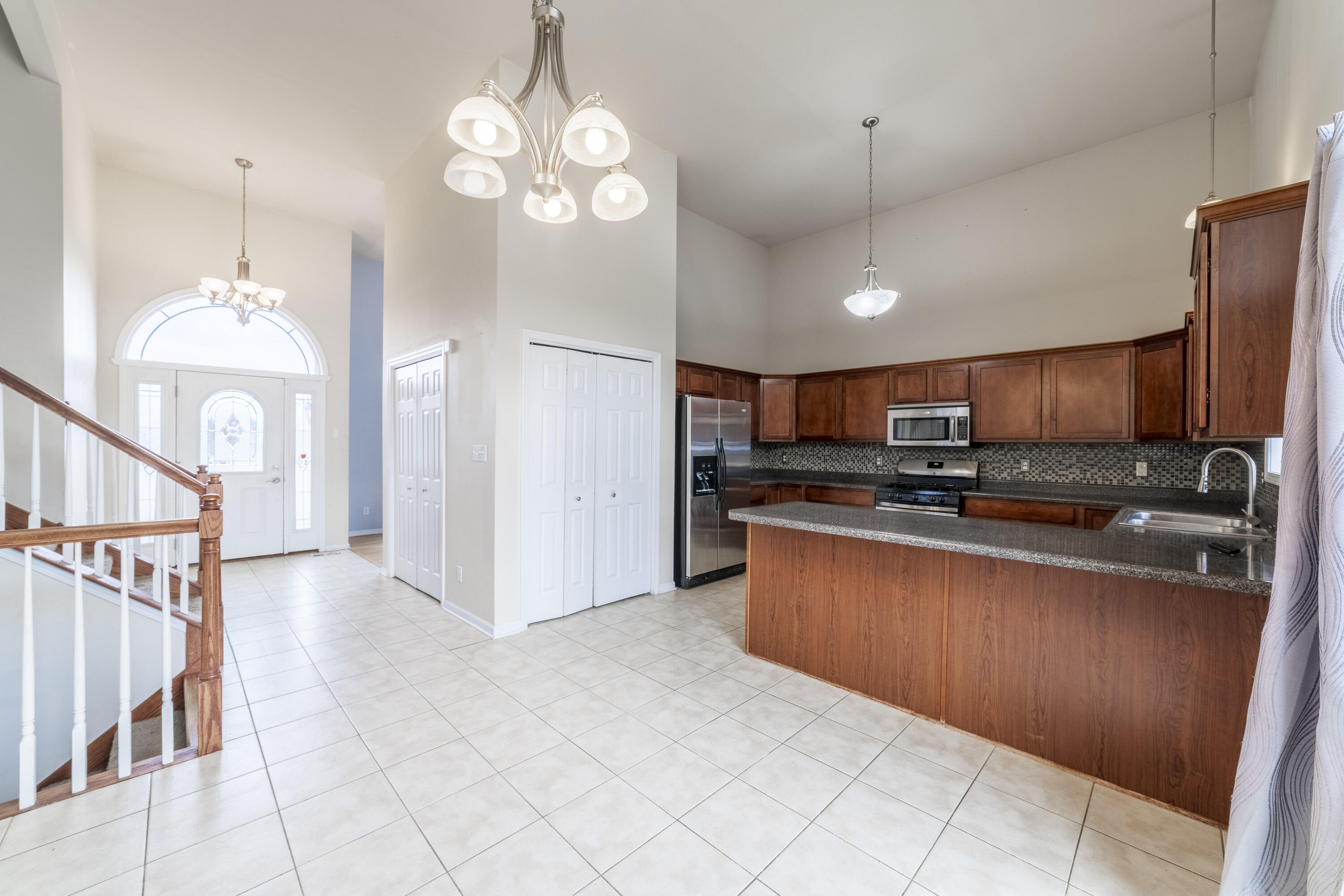 12719 Wheeler Street Cedar Lake, IN 46303 - Photo 12 of 48 a open kitchen with stainless steel appliances granite countertop a refrigerator oven a sink dishwasher and white cabinets with wooden floor
