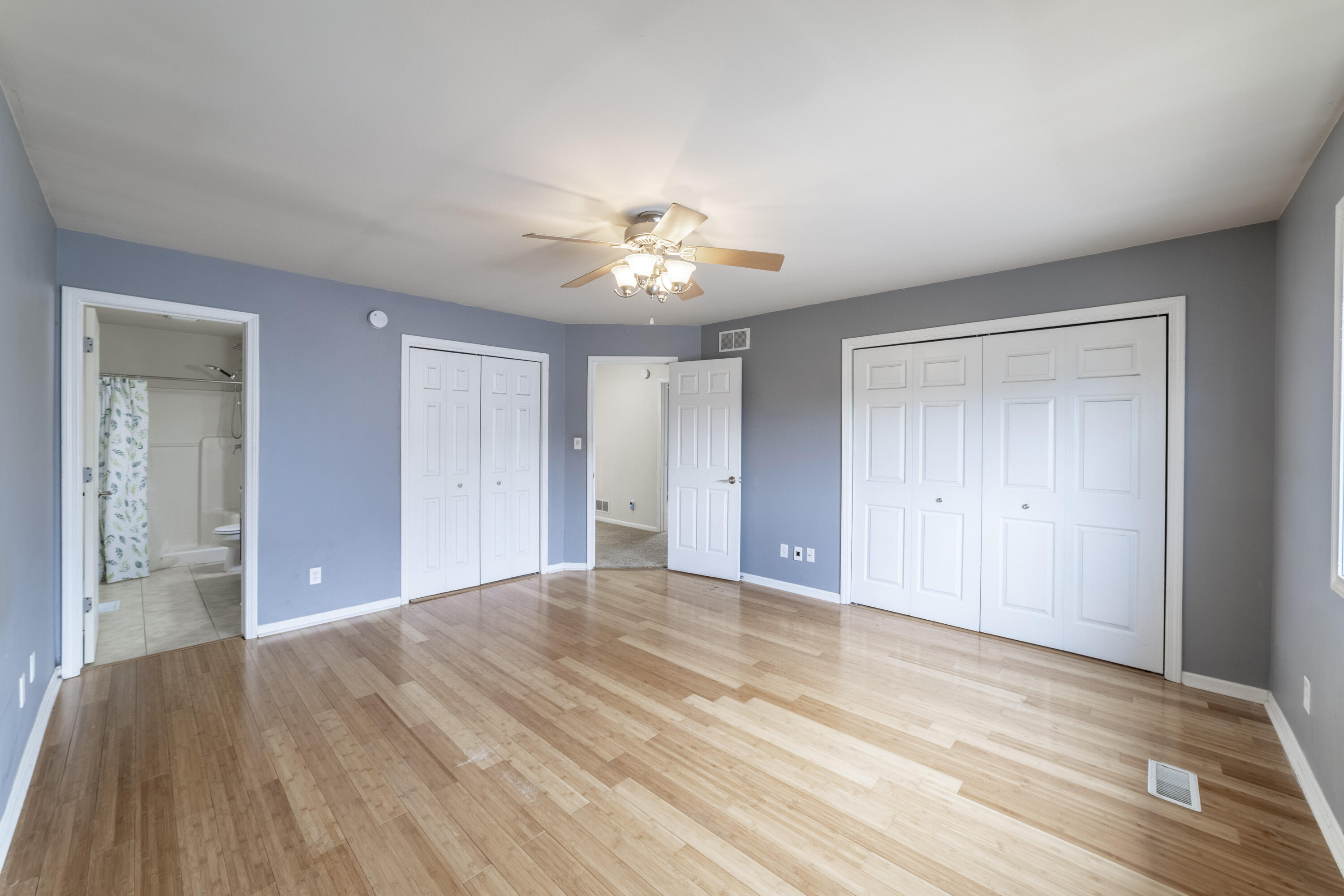 12719 Wheeler Street Cedar Lake, IN 46303 - Photo 17 of 48 a view of an empty room with chandelier fan and wooden floor
