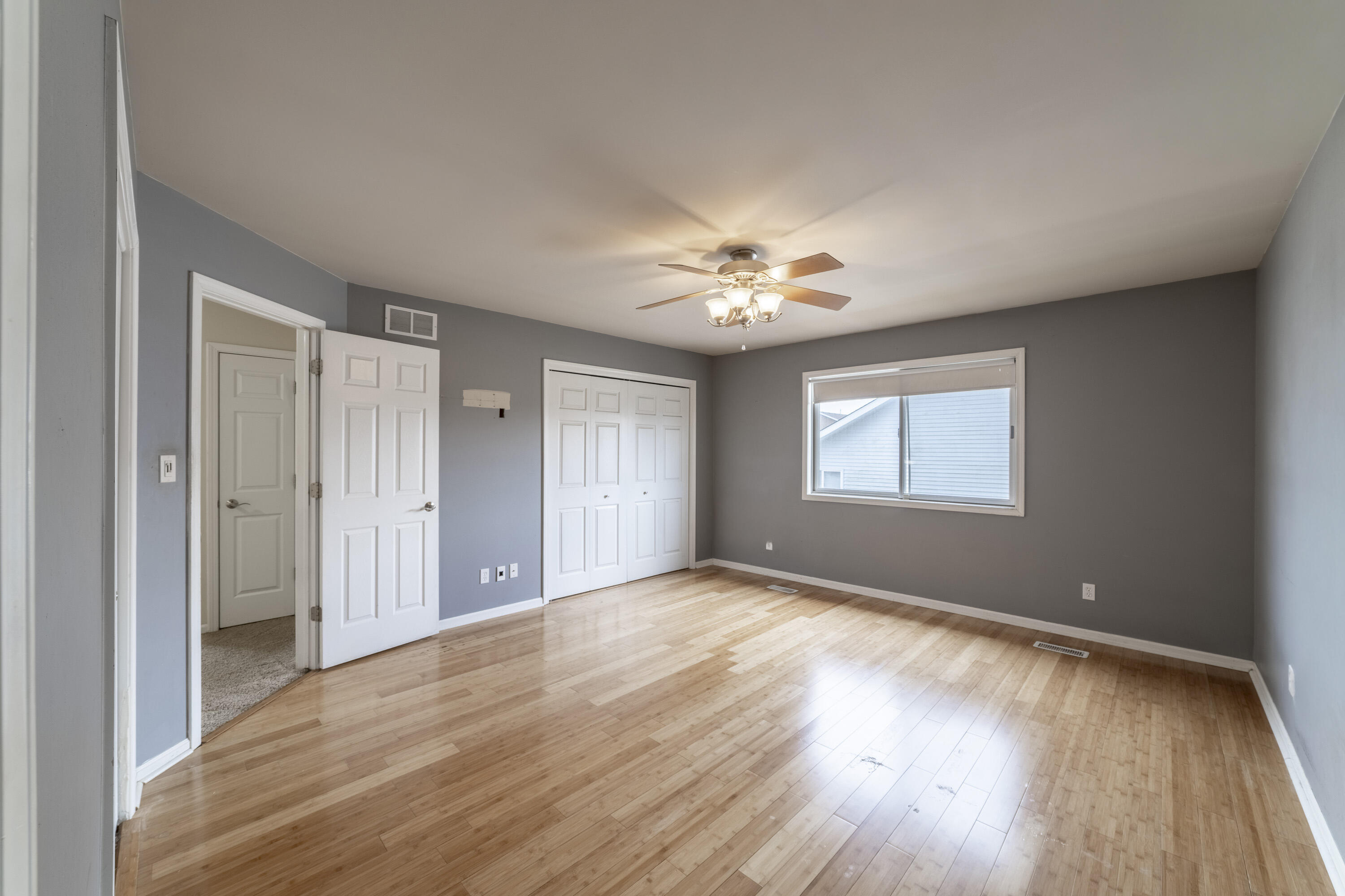 12719 Wheeler Street Cedar Lake, IN 46303 - Photo 19 of 48 a view of an empty room with a window and wooden floor