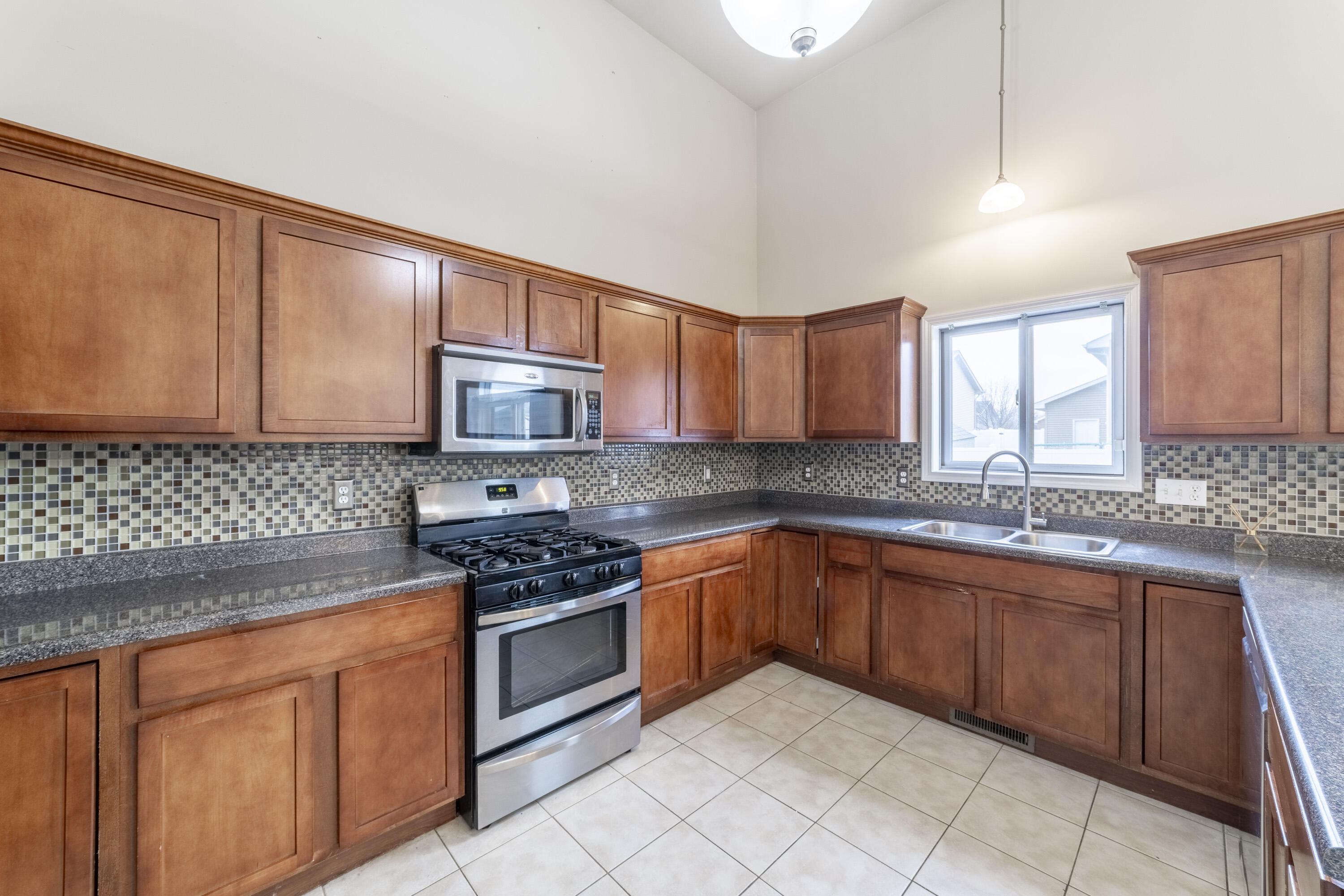 12719 Wheeler Street Cedar Lake, IN 46303 - Photo 10 of 48 a kitchen with stainless steel appliances granite countertop wooden cabinets a stove top oven a sink and dishwasher
