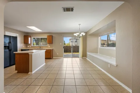 a large kitchen with cabinets and stainless steel appliances