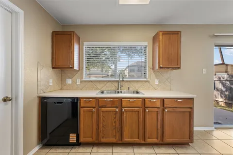 a kitchen with a sink and a window