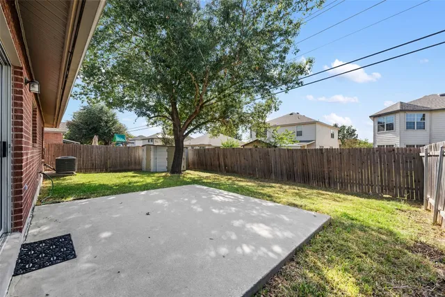 a view of a backyard with wooden fence